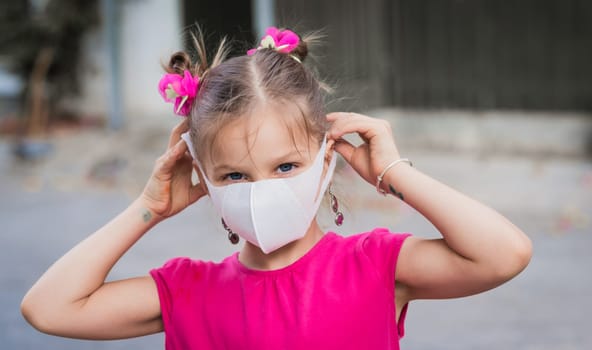 Girl wearing facial disposable mask to avoid viral infection. Virus protection