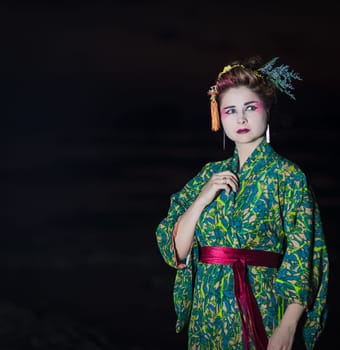Fine art portrait of european woman in Japanese Geisha style wearing kimono