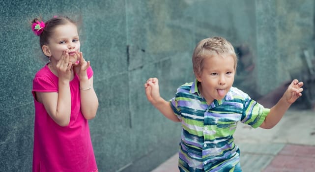Boy and girl doing funny faces outdoor