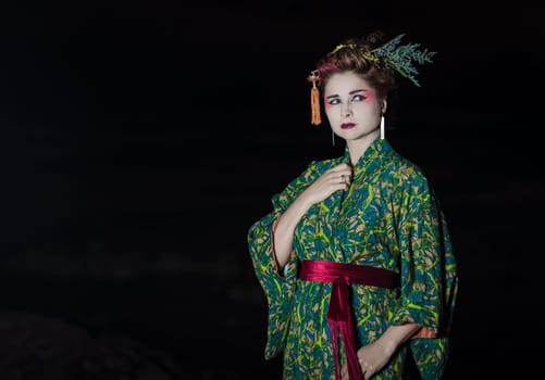 Fine art portrait of european woman in Japanese Geisha style wearing kimono
