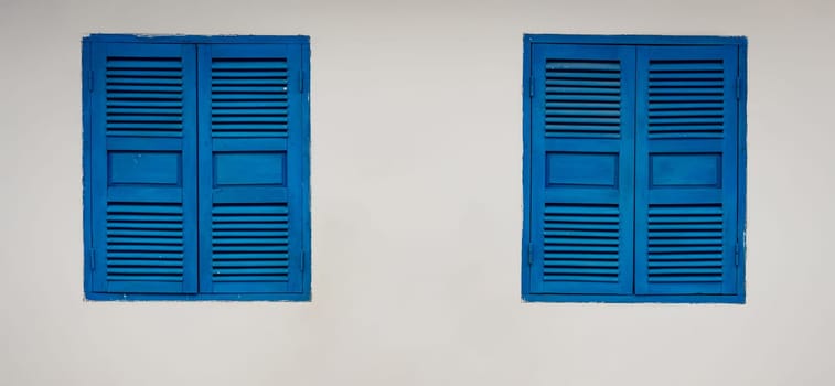 White wall with closed shatter windows