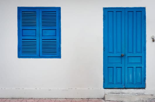 White wall with closed shatter window and door