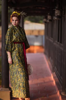 Fine art portrait of beautiful woman in Japanese Geisha style wearing kimono