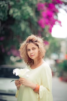 Outdoor portrait of a beautiful woman with flower