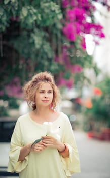 Outdoor portrait of a beautiful woman with flower