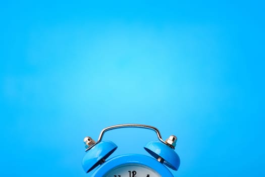 Close-up of an alarm clock, above it an empty place