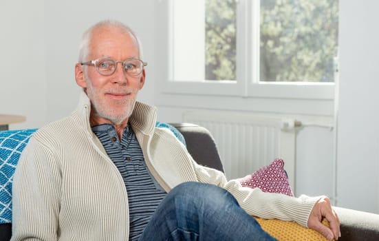 Senior man with grey hairs wearing eyeglasses