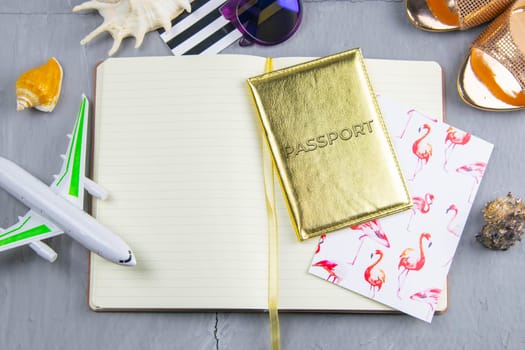 Travel concept. Preparation for the tour: passport, women's shoes, plane, glasses, tanning oil and seashells.