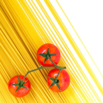 Traditional italian food. Uncooked spaghetti pasta and cherry tomato isolated on white background. Flat lay. Copy space.