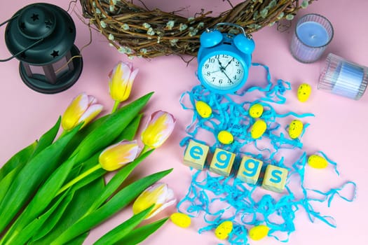 Word Easter on wooden cubes and surrounded with multiple egg decorations as a festive Easter background composition.