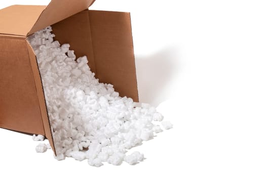 Cardbox spills plenty of polystyrene or white styrofoam packing pieces used for minimize bumps in transportation of goods.
