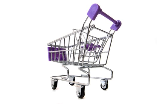 Miniature shopping cart isolated on white background.