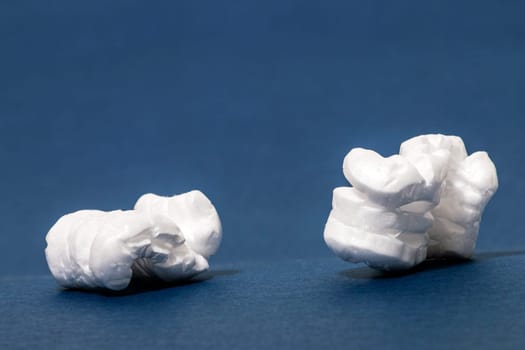 Polystyrene or white styrofoam packing pieces used for minimize bumps in transportation of goods.