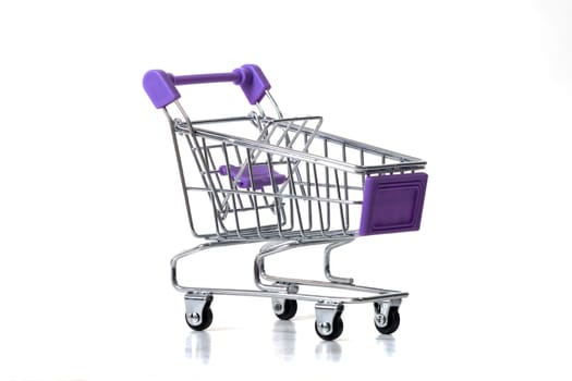 Miniature shopping cart isolated on white background.