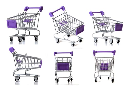 Miniature shopping carts in various angles isolated on a white background.