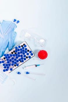 Several laboratory objects including protective mask, vial rack, testing tubes and other stuff.