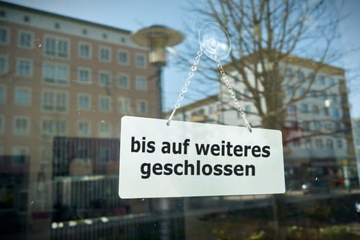 Sign on a shop window with the inscription closed until further notice