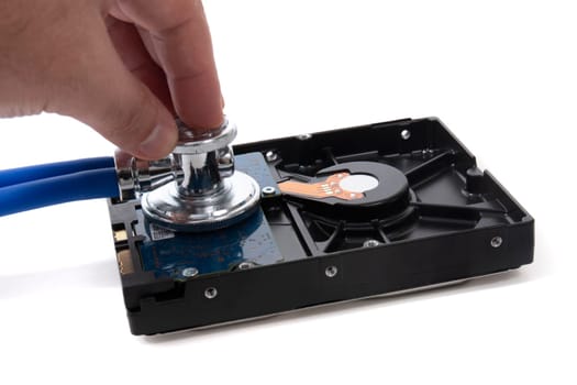 Stethoscope and hard disk drive isolated on a white background.