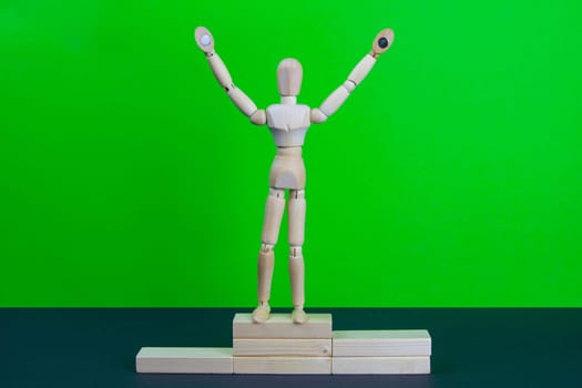 Full length portrait of male winner on winner's pedestal, on green background. The composition of 3 components: 1 place winner.