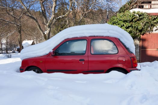 Red car sunken in snow, Czech Republic