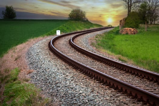 A large long train on a train track with trees in the backgroundundefined