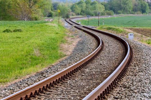 A large long train on a train track with trees in the backgroundundefined