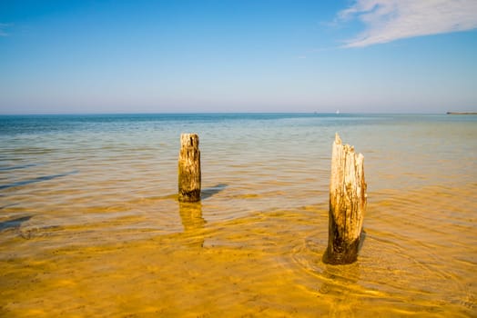 old groins in the Baltic Sea with blue sky