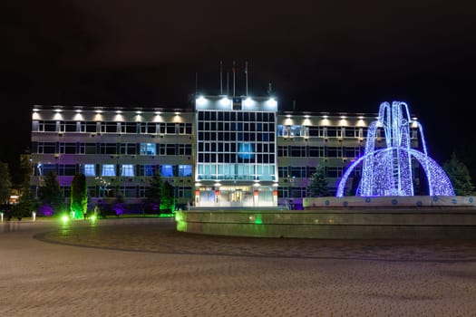 Anapa, Russia - February 28, 2020: View of the administration of Anapa and the winter fountain in front of it after sunset