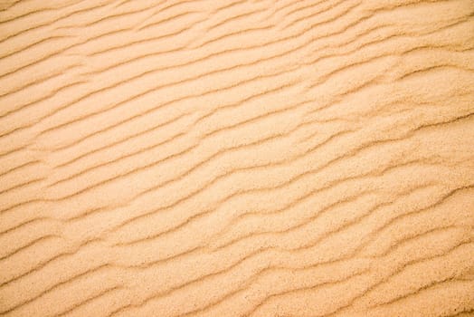 Sand of a beach with wave patterns