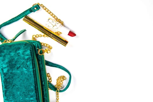 Tulips with green women's clutch and women's cosmetics on a white background.