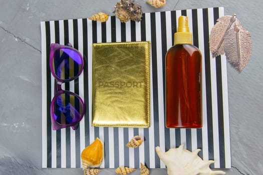 Travel concept. Preparation for the tour: passport, women's shoes, plane, glasses, tanning oil and seashells.
