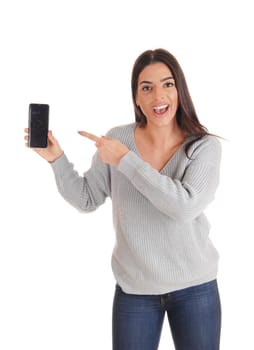 A happy young slim women standing in the studio in jeans and.talking a selfie whit her cell phone, isolated for white background.
