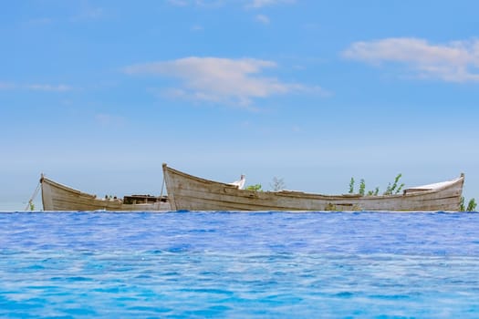 Two Old Boats between Swimming Pool and Sea