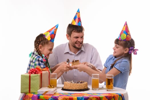 Dad and two daughters fight for the first piece of the holiday cake
