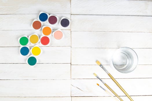 Top view on colorful paints and brushes. Creative ideas, creativity and early learning. Education concept.