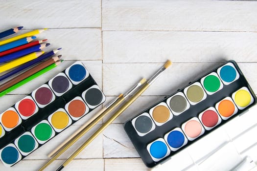 Top view on colorful paints and brushes. Creative ideas, creativity and early learning. Education concept.