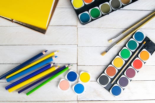 Top view on colorful paints and brushes. Creative ideas, creativity and early learning. Education concept.