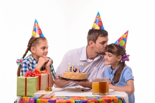 Dad congratulates daughter on his birthday and kisses her
