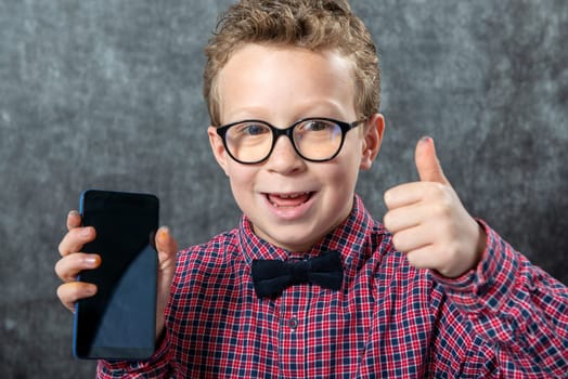 Little boy showing a smartphone black blank screen