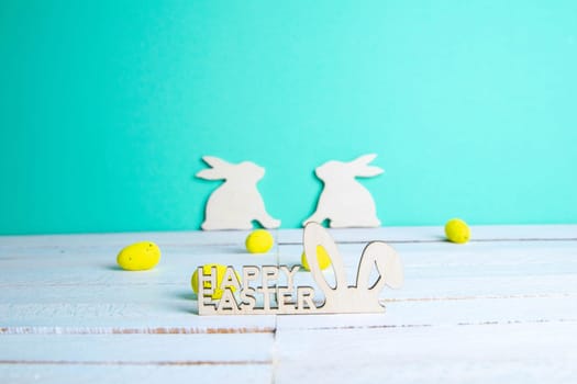 Easter holiday background. Easter bunny, eggs and text Happy Easter. Minimal modern concept.