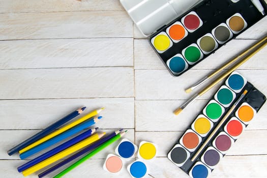 Top view on colorful paints and brushes. Creative ideas, creativity and early learning. Education concept.
