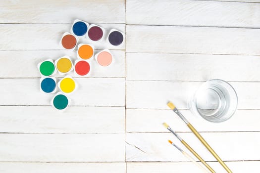 Top view on colorful paints and brushes. Creative ideas, creativity and early learning. Education concept.