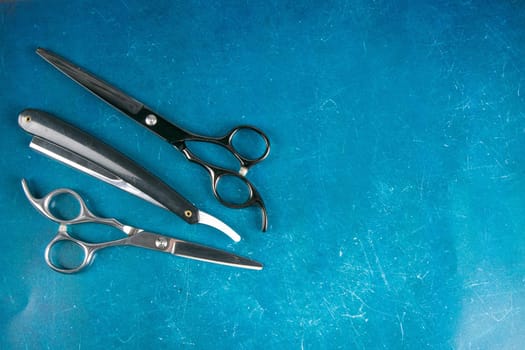 Scissors on blue background. Barber shop concept.