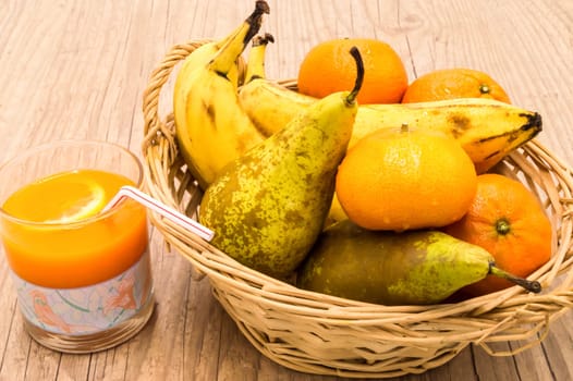 Healthy food. Organic fruits and vegetables with multifruit juice on a wooden background