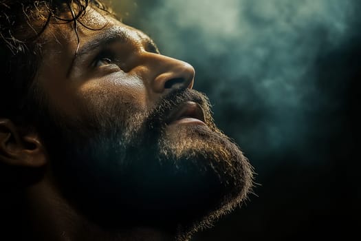 A man, sweaty and focused, looks upward. Exhaustion and exertion are evident. The image suggests intense physical activity.