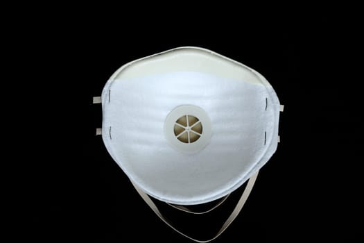 Protection White Surgical Mask FFP2 To Protect Against Virus Infection Coronavirus COVID-19, Isolated On Black Background