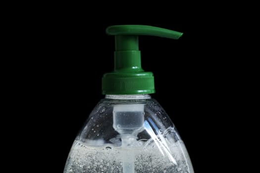 Hand-Washing To Prevent Coronavirus (COVID-19) Concept, Rising Soap Bubbles In Pump Plastic Bottle On The Black Background. Close Up / Macro Shot