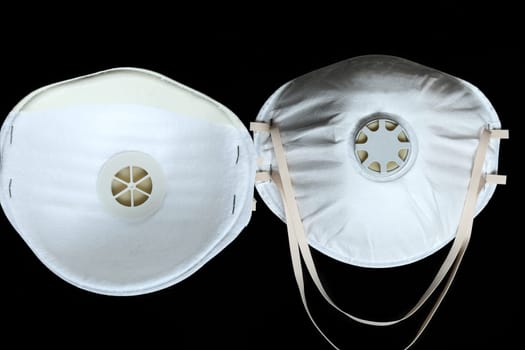 Two Protection White Surgical Masks FFP2 To Protect Against Virus Infection Coronavirus COVID-19, Isolated On Black Background