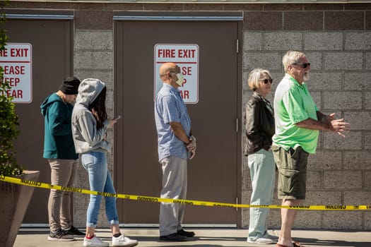 TUCSON, UNITED STATES  - March 29: Shoppers practicing social distancing lined up outside retail warehouse store in Tucson during the coronavirus pandemic.. March 29, 2020 in Tucson, Arizona, USA.