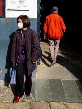 SEVILLE, SPAIN  - March 7: Unidentified woman wearing mask to protect herself and others from coronavirus. March 7, 2020 in Seville, Spain.